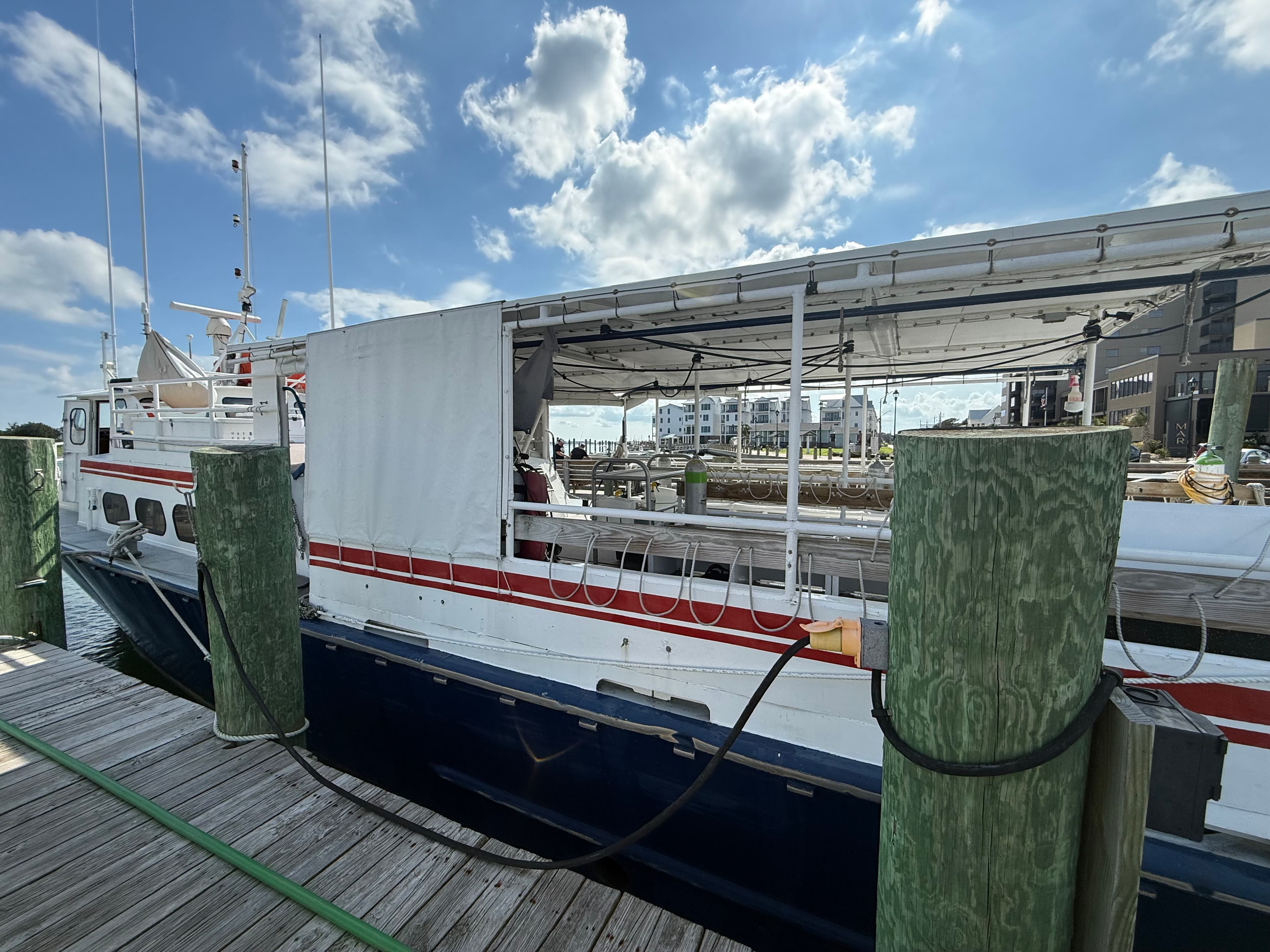 A dive boat secured alongside a marina dock