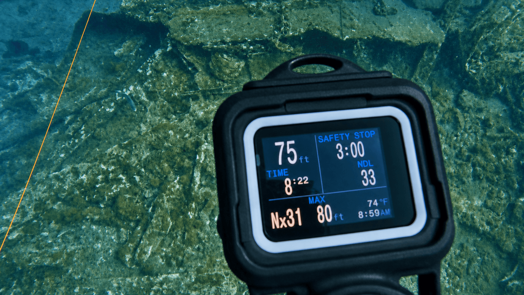 An unbranded dive computer above an underwater shipwreck